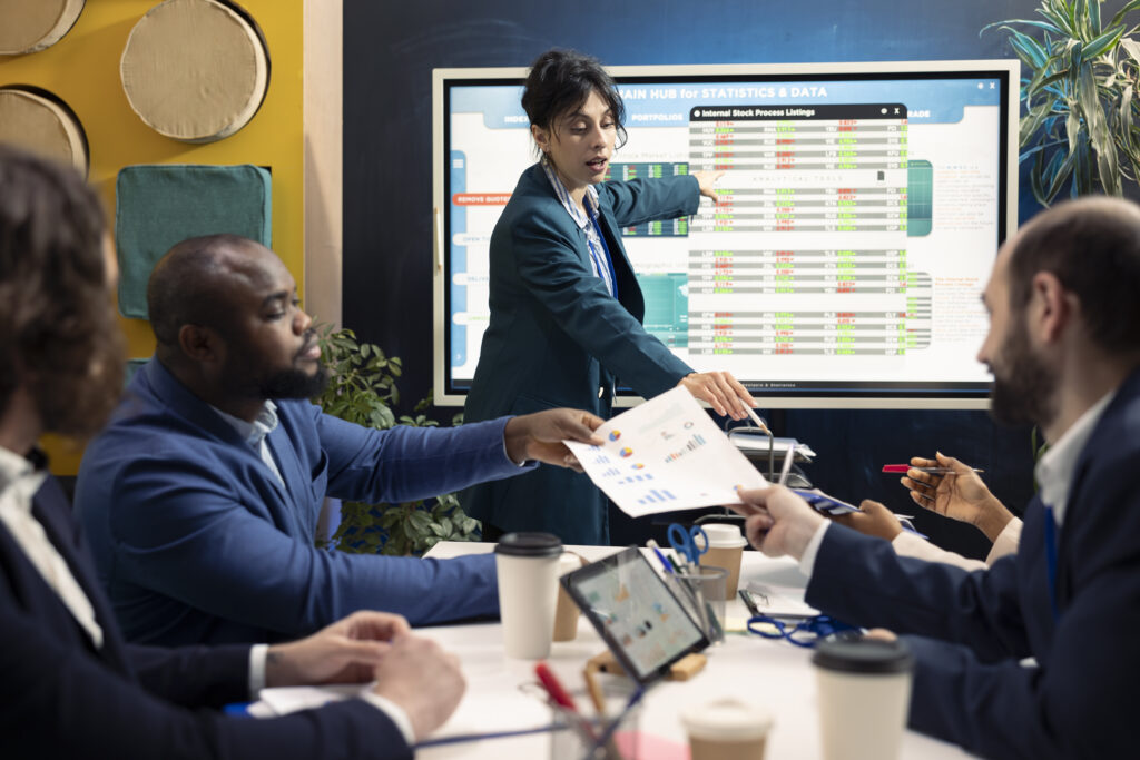 A group of business professionals engaged in a presentation in a conference room